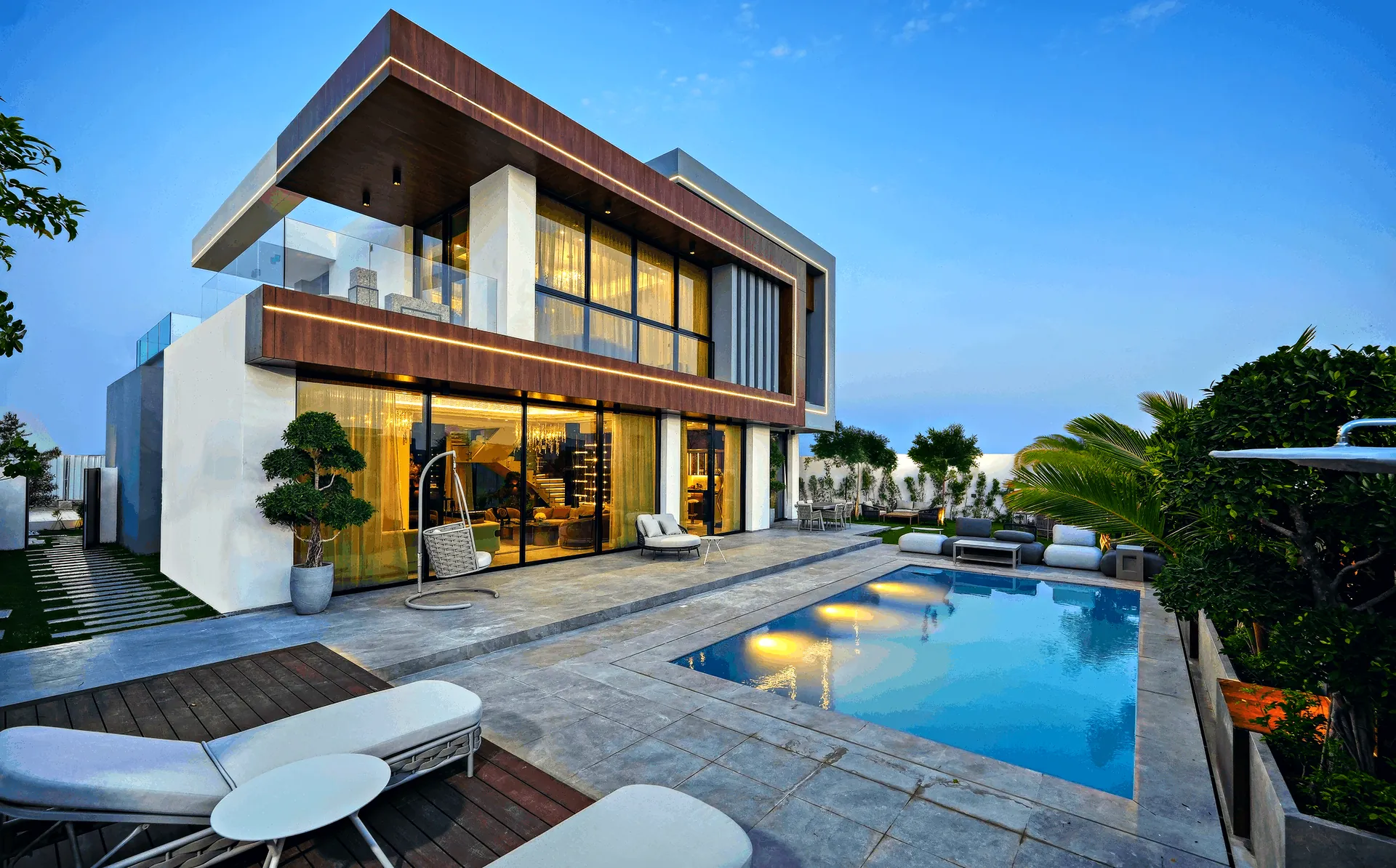A completed villa at Ohana By The Sea at dusk, with its pool