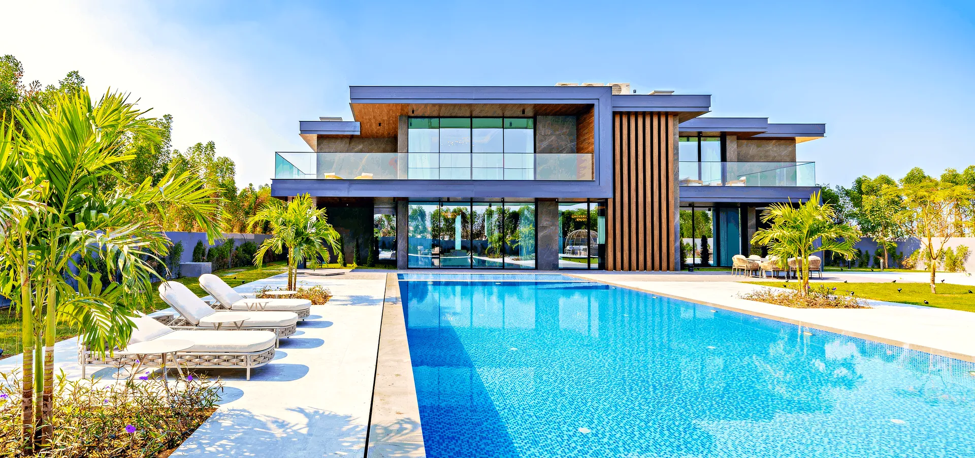 A villa and its long pool at Ohana By The Sea in daylight